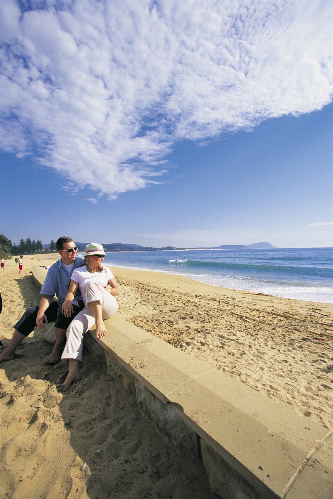 A couple overlooks the beach